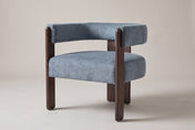 Chioggia velvet accent chair in Blue, three-quarter view on a warm studio backdrop