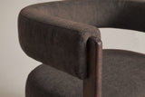 Close-up of the dark brown velvet back band ending on the rounded top of a walnut front leg