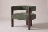 Chioggia velvet accent chair in Olive Green, three-quarter view on a warm studio backdrop