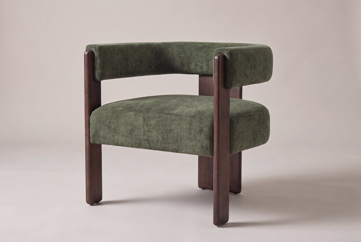 Chioggia velvet accent chair in Olive Green, three-quarter view on a warm studio backdrop