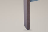 Close-up of a walnut-stained front leg of the Chioggia chair with its rounded foot