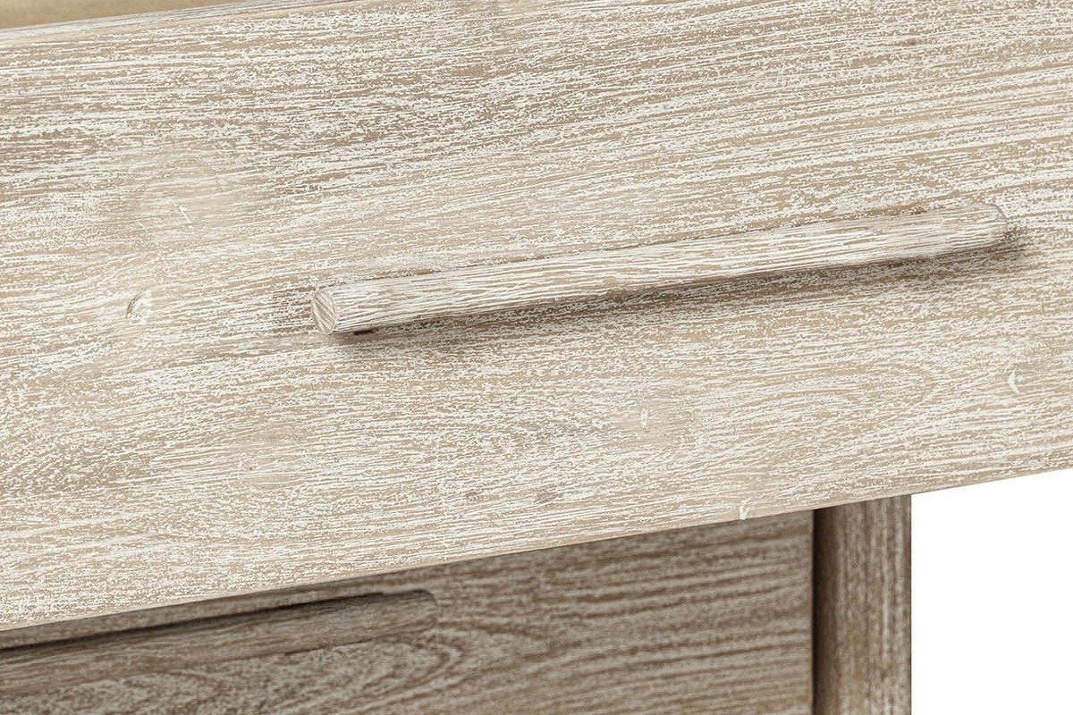 Close-up of a Chiusdino drawer front: the slim bar pull and the pale whitewash over the grain