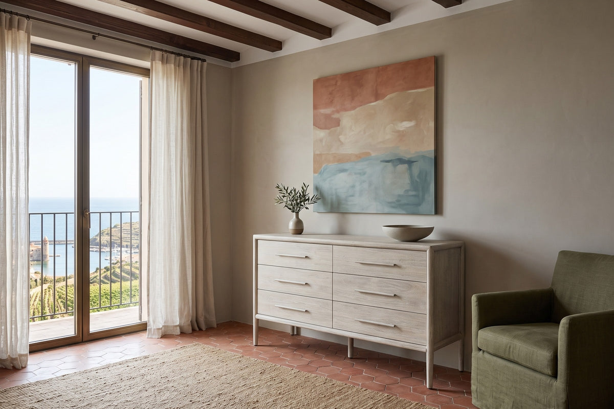 Chiusdino dresser in a pale whitewashed finish against a greige plaster wall in a Collioure house, with chestnut beams