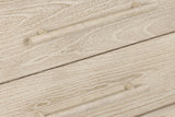 Close-up of the Chiusdino drawers: round wooden bar pulls, each on two short posts
