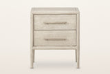 Chiusdino nightstand in whitewashed wood, front view on a warm white studio backdrop: two equal drawers