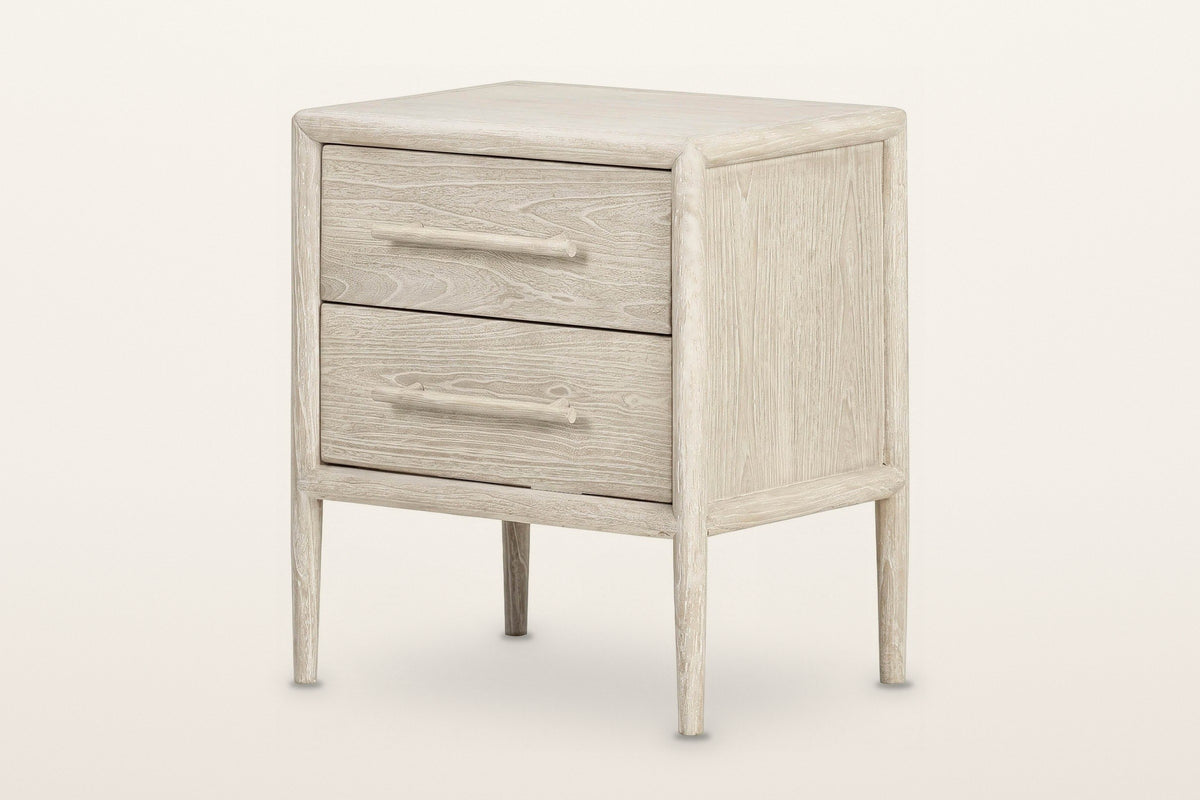 Chiusdino nightstand in whitewashed wood, three-quarter view on a warm white studio backdrop: two drawers with round wooden b