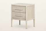 Chiusdino nightstand in whitewashed wood, three-quarter view on a warm white studio backdrop: two drawers with round wooden b