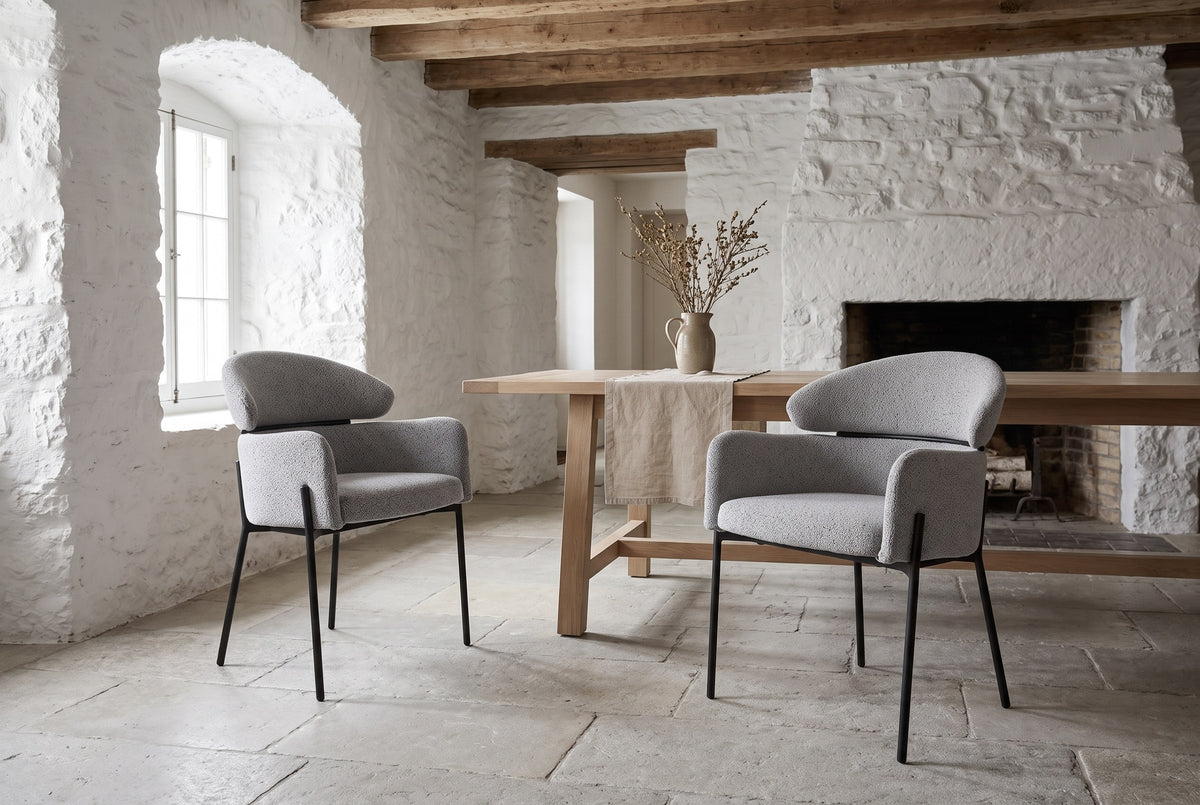 Two Chiusi dining chairs in a whitewashed stone dining room in Quebec City