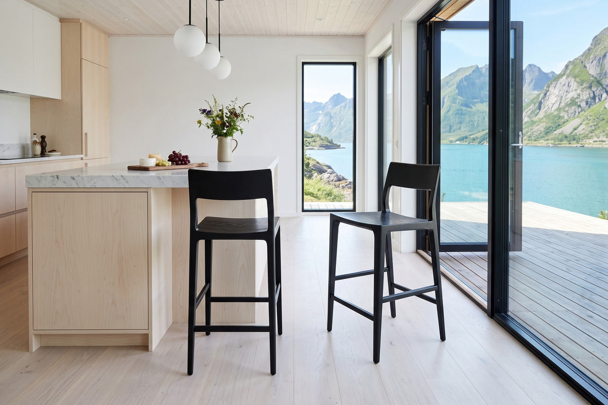Two Cison counter stools in Black at a white marble island in a house in Reine, Lofoten