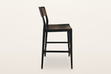 Cison counter stool in Black, side view on a warm white studio backdrop