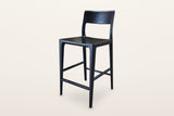 Cison solid ash counter stool in Black, three-quarter view on a warm white studio backdrop: black ash with a black metal foot