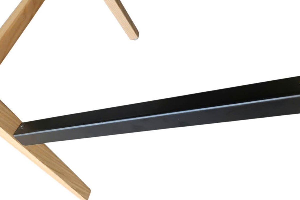 Close-up of the Cison footrest: a flat black metal bar fixed into the ash legs with small screws