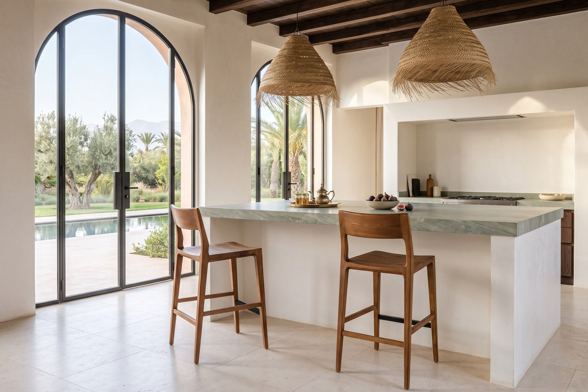 Two Cison counter stools in Warm Brown at a green-grey quartzite island in a Marrakech villa, with tadelakt walls