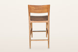 Cison counter stool in Warm Brown from behind on a warm white studio backdrop