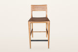 Cison counter stool in Warm Brown, straight front view on a warm white studio backdrop