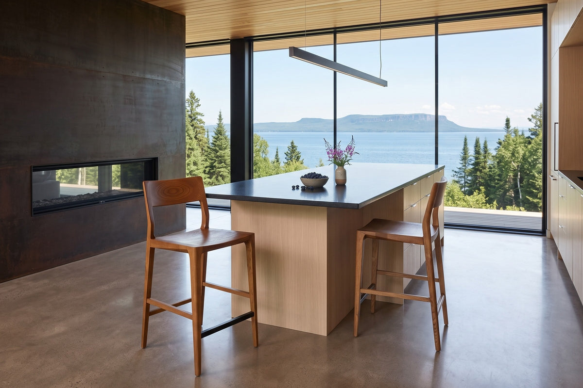 Two Cison counter stools in Warm Brown at a black granite island in a Thunder Bay house