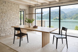 Two Cison dining chairs in Black at a light-oak table in a Lake Bled villa