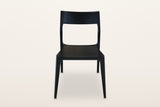 Cison dining chair in Black, front view on a warm white studio backdrop: the wide backrest on top of the posts