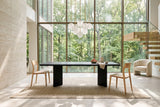 Cison dining chairs in Natural at the two ends of a black oak table in a Rouge Valley ravine house