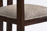 Close-up of the light brown boucle seat, the square front leg and the espresso wire-brushed wood frame of the Cisternino chai