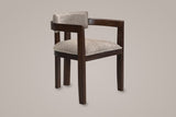 Cisternino dining armchair in Espresso with a light brown boucle seat, three-quarter view on a warm grey studio backdrop