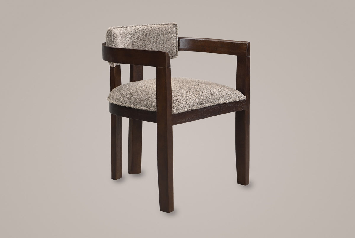 Cisternino dining armchair in Espresso with a light brown boucle seat, three-quarter view on a warm grey studio backdrop