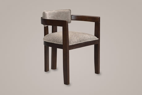 Cisternino dining armchair in Espresso with a light brown boucle seat, three-quarter view on a warm grey studio backdrop