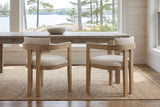 Two Cisternino chairs at a pine table in a Muskoka cottage with a window onto the lake