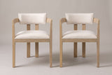 A set of two Cisternino dining armchairs in Light Ash, straight front view on a studio backdrop