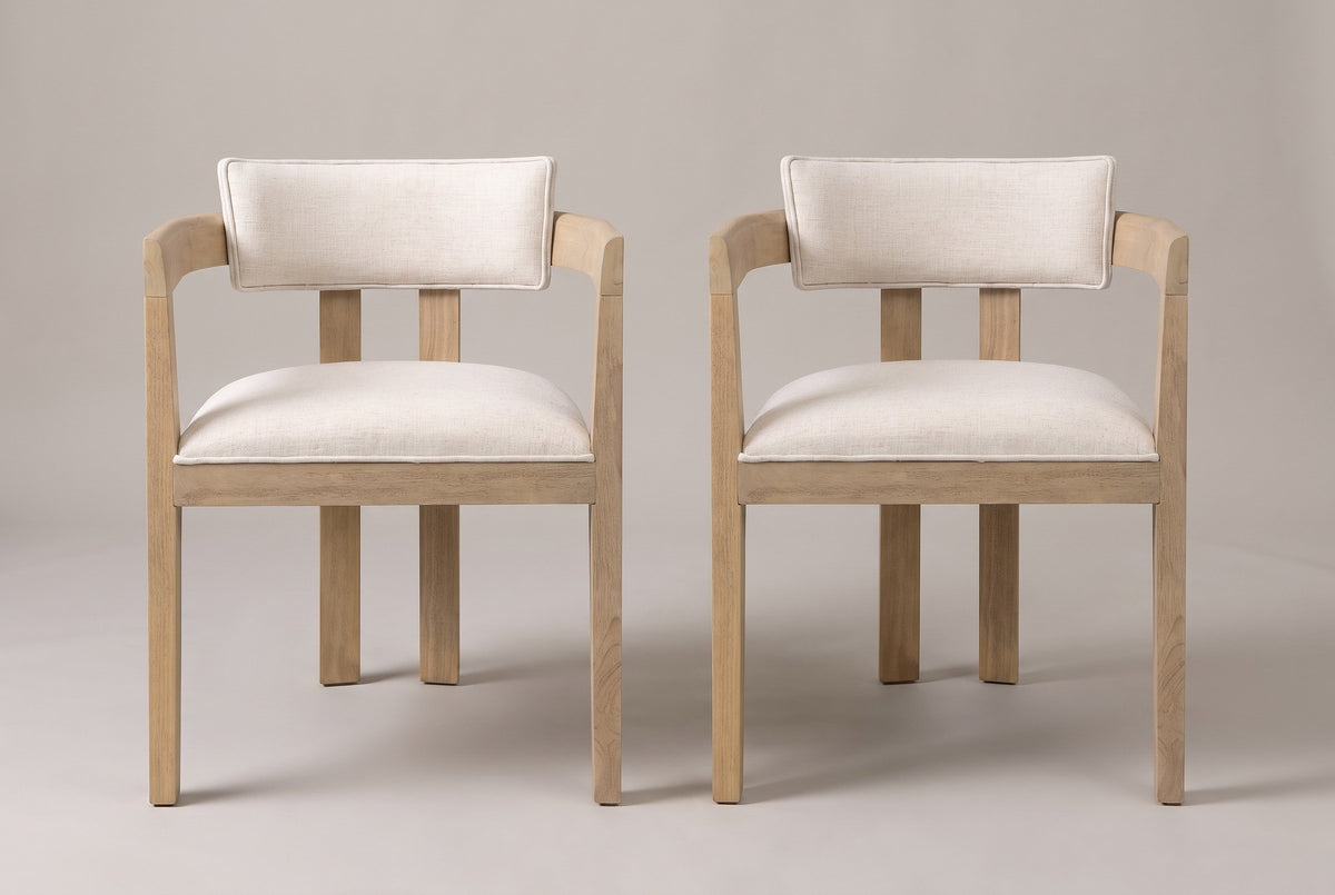 A set of two Cisternino dining armchairs in Light Ash, straight front view on a studio backdrop