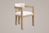 Cisternino dining armchair in Light Ash with a beige linen-look seat, three-quarter view on a warm grey studio backdrop