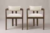 A set of two Cisternino dining armchairs in Walnut with beige linen-look seats, straight front view on a studio backdrop