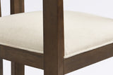 Close-up of the welted beige linen-look seat, the square front leg and the brushed walnut frame of the Cisternino chair