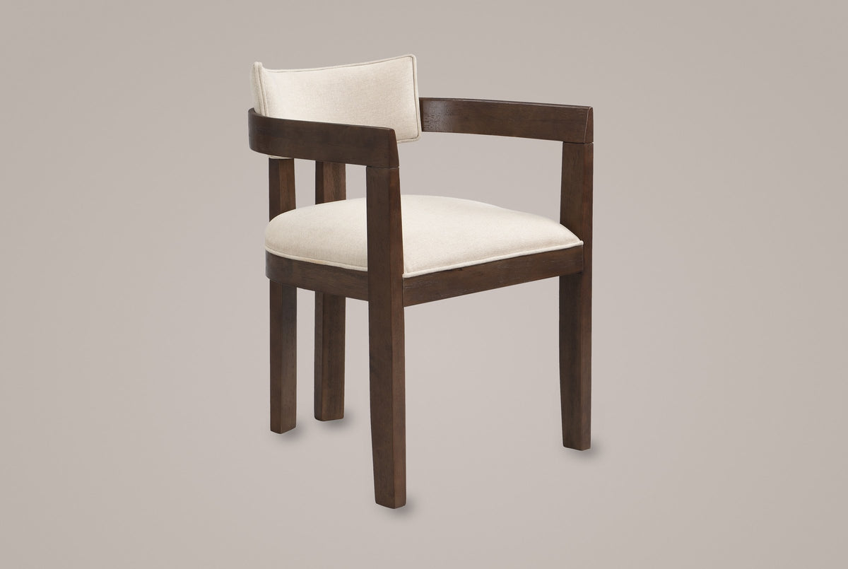 Cisternino dining armchair in Walnut with a beige linen-look seat, three-quarter view on a warm grey studio backdrop