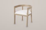 Civita horseshoe dining chair in Beige, three-quarter view on a warm light-grey studio backdrop