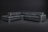 The Clara sectional against a dark studio backdrop, headrests down, the chaise on the left. Shown in distressed full-aniline leather, Aged Slate, Left bumper.