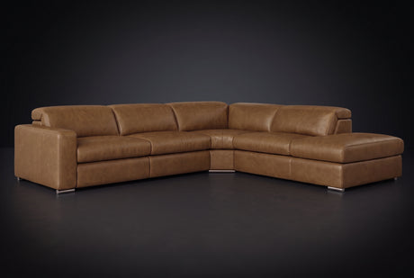 The Clara sectional against a dark studio backdrop, headrests down, the chaise on the right. Shown in distressed full-aniline leather, Weathered Saddle, Right bumper.