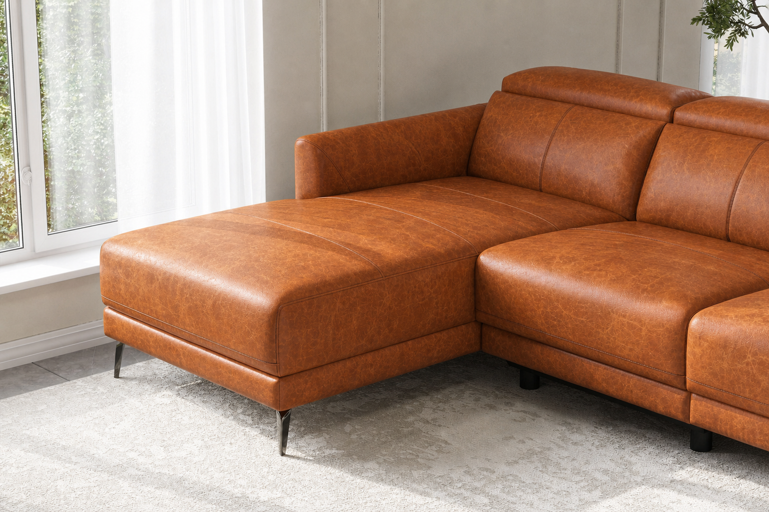Close-up of the Andria cognac leather chaise, corner seat, and slim black metal legs