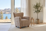 Collodi chair in Beige Brown chenille in a bright Kelowna lake-house living room with an olive tree and a pale oak side table
