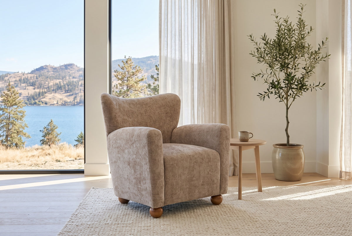 Collodi chair in Beige Brown chenille in a bright Kelowna lake-house living room with an olive tree and a pale oak side table
