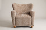 Collodi chair in Beige Brown, straight front view: waved wingback, two round arms, solid wood ball feet