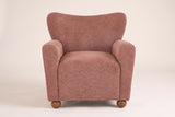 Collodi chair in Coral, straight front view: waved wingback, two round arms, solid wood ball feet