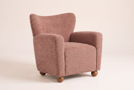 Collodi wingback accent chair in Coral, three-quarter view on a warm off-white backdrop