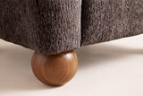 Close-up of a solid wood ball foot under the Dark Brown upholstered corner of the Collodi chair