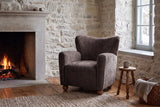 Collodi chair in Dark Brown in a Quebec City stone sitting room with a low fire, a turned stool and snowy daylight