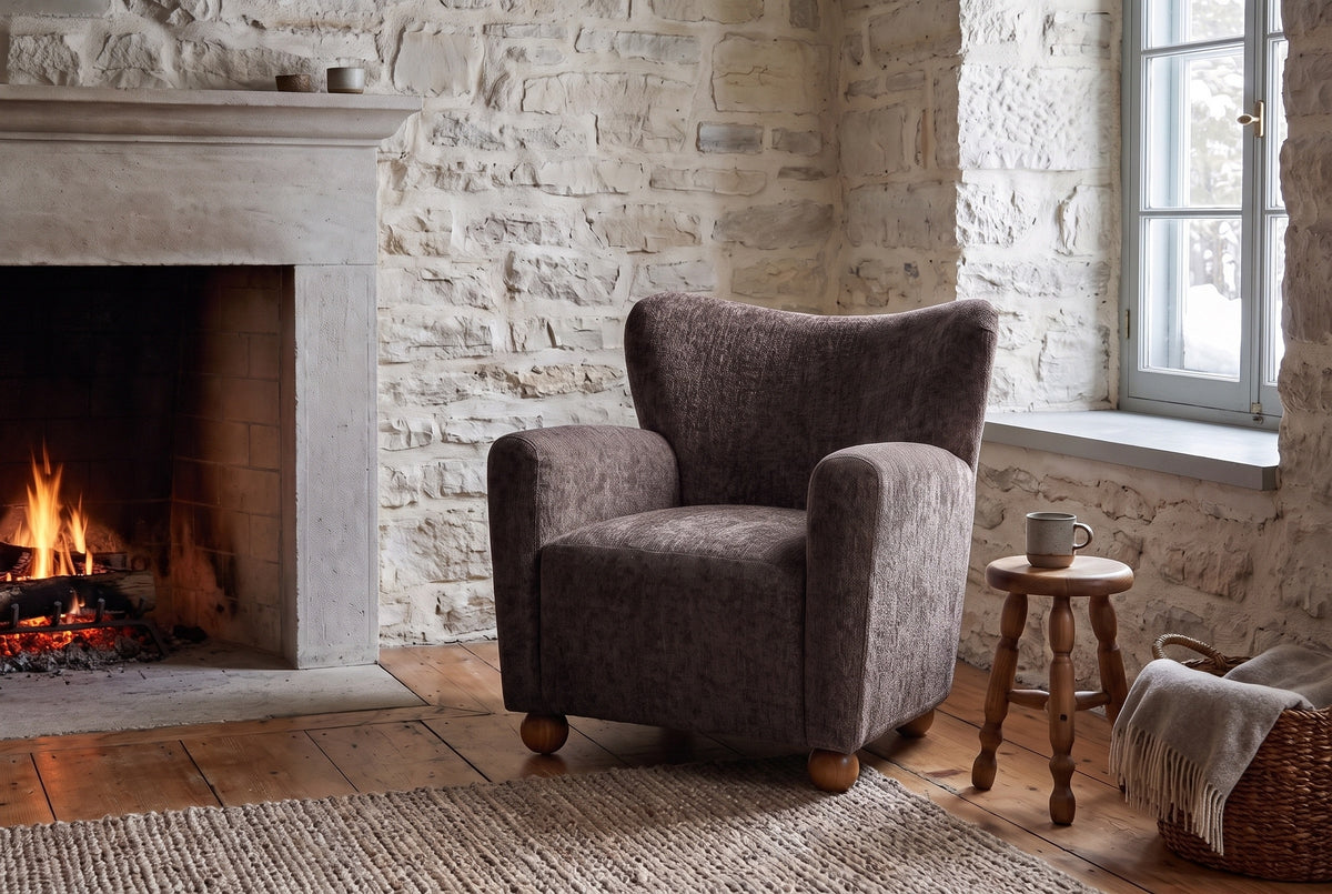 Collodi chair in Dark Brown in a Quebec City stone sitting room with a low fire, a turned stool and snowy daylight