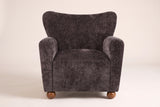 Collodi chair in Dark Brown, straight front view: waved wingback, two round arms, solid wood ball feet