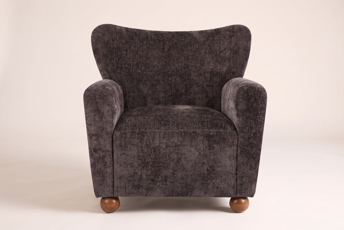 Collodi chair in Dark Brown, straight front view: waved wingback, two round arms, solid wood ball feet