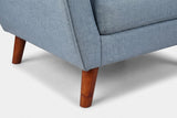 Close-up of the front corner and a tapered solid wood leg in a walnut finish