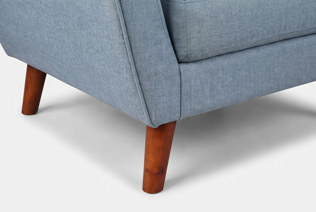 Close-up of the front corner and a tapered solid wood leg in a walnut finish